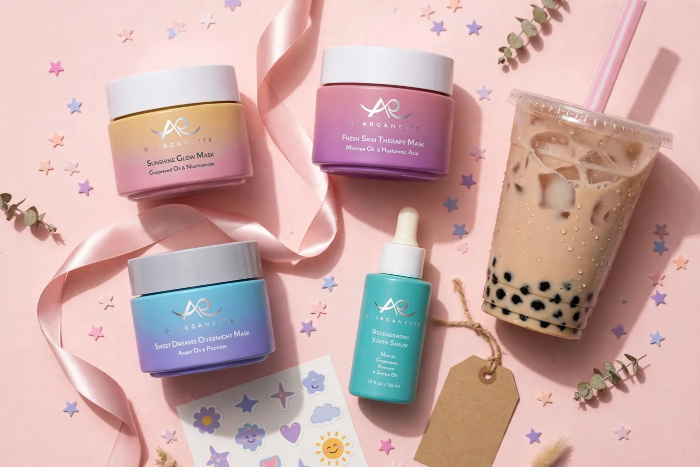 The four D'Arganette products arranged as a gift set with ribbon, star confetti, stickers and a boba tea