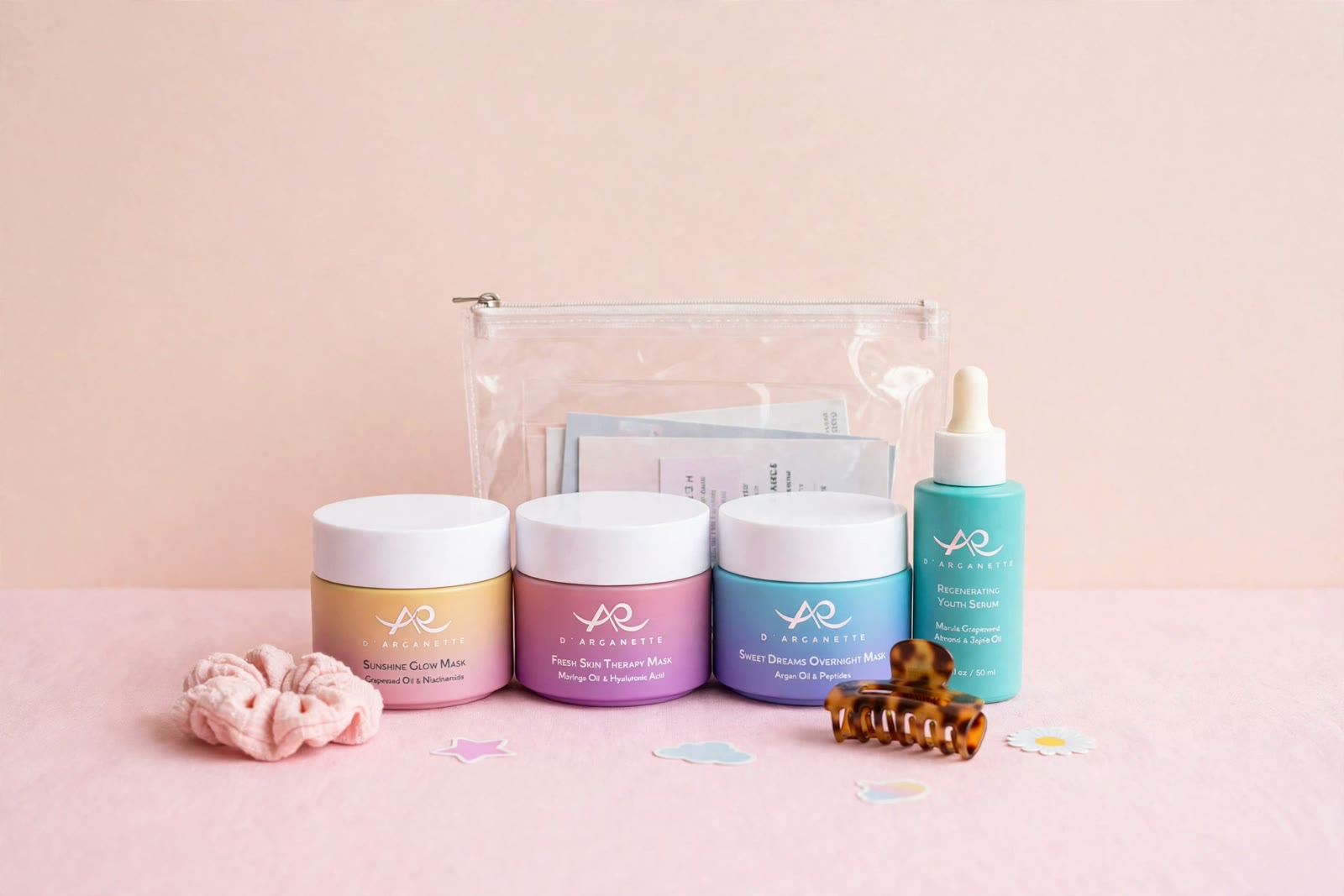 The Squad Pass: all four D'Arganette products lined up in front of a clear zip pouch, with a scrunchie and a claw clip